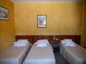 Postel nebo postele na pokoji v ubytování Hotel Beau Rivage