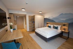 a bedroom with a bed with a mountain mural on the wall at Leo Apartments Miesbach in Miesbach