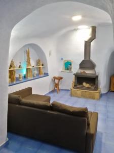 a living room with a couch and a fireplace at Casa Rural Rio Chicamo in La Umbría