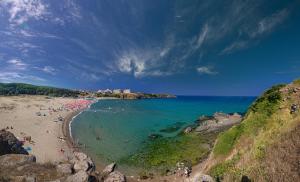 a beach with a bunch of people in the water at Apart Hotel Apolonia Palace in Sinemorets