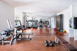 a gym with several treadmills and machines in it at Danai Beach Resort & Villas in Nikiti