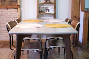 a table with four chairs around it at Casa rural fuentelgato in Huerta del Marquesado