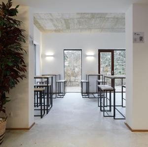a row of bar stools in a room with windows at IRAIPE Estella Rooms Auto Check-in in Estella