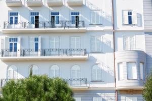 a facade of a building with windows and balconies at Hostel Link in Lovran