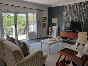 a living room with a couch and a television at Military House in Pietermaritzburg