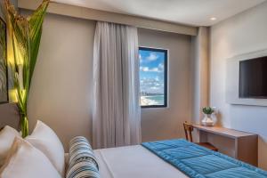 Postel nebo postele na pokoji v ubytování Hotel Água de Coco