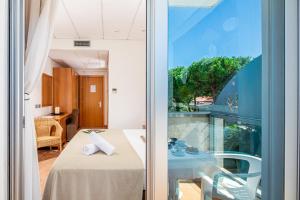Postel nebo postele na pokoji v ubytování Hotel Rex