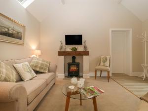 a living room with a couch and a fireplace at Cow Drove Cottage in Salisbury