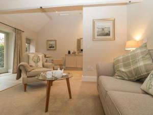 a living room with a couch and a table at Cow Drove Cottage in Salisbury