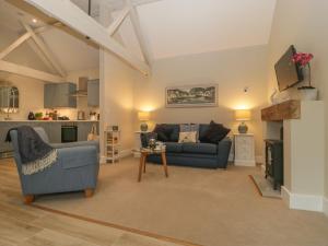 a living room with a couch and a table at Barn Owl Cottage in Salisbury