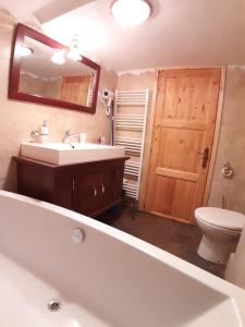 a bathroom with a tub and a sink and a toilet at Apartament Mario in Sibiu +24 photos
