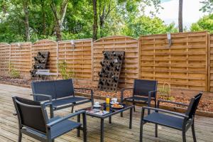 two chairs and a table in front of a fence at Sure Hotel by Best Western Reims Nord in Reims