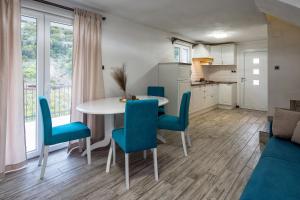 a kitchen and dining room with a table and chairs at Holiday home Beyla in Pučišća