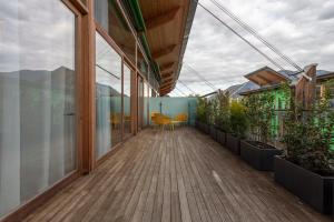 a balcony of a house with a view of the mountains at Habitat Guest House in Trento