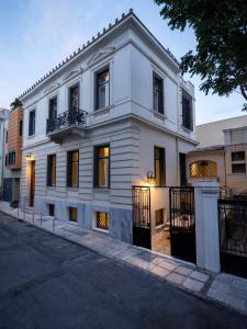 a white building on the side of a street at The White House in Plaka by JJ Hospitality in Athens