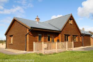 a log cabin with a black roof at 22 Drumcoura Lake Resort Holid in Ballinamore