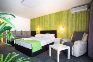 a hotel room with a bed and a couch at Hotel Bio in Koper