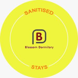 a yellow circle with the words sanitizedizonsizonsizonsizonsbestosbestosoren conformity at Blossom Dormitory For Male and Female in Mumbai