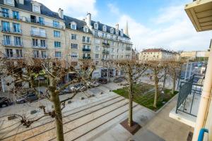 a view from the balcony of a building with trees at Logis Hotel Du Chateau in Caen