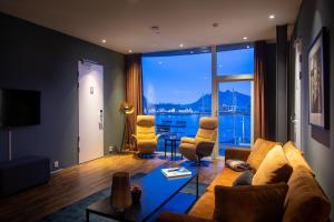 a living room with a couch and a large window at Nordis Apartments in Svolv&aelig;r