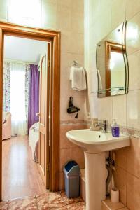 a bathroom with a sink and a mirror at Nevsky Row Hotel - Nevsky 100 in Saint Petersburg