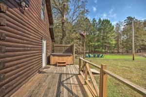 a wooden deck with a hot tub on the side of a house at Peaceful Pet-Friendly Retreat with Private Hot Tub! in Broken Bow