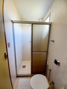 a shower stall with a toilet in a bathroom at Praia do morro com Wi-Fi in Guarapari