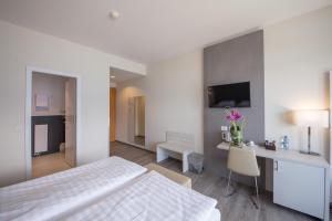 Postel nebo postele na pokoji v ubytování Hôtel Prealpina