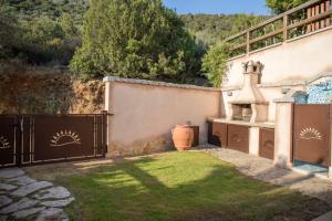 a house with a gate and a yard with a yard at Sobìa Pitticca in Chia