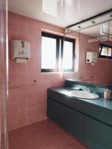 a bathroom with a sink and a mirror at Impact House Belém in Lisbon