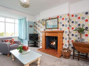 sala de estar con chimenea y espejo en Bryngwyn - Trearddur Bay, en Holyhead