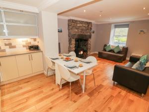 a kitchen and living room with a table and chairs at Annest in Bangor