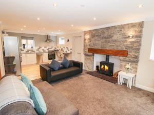 a living room with a couch and a fireplace at Bryn in Bangor