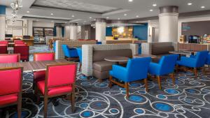a restaurant with colorful chairs and tables in a lobby at Holiday Inn Express - Kansas City Downtown, an IHG Hotel in Kansas City