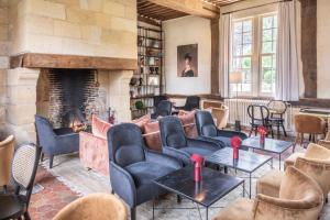 a living room with couches and a fireplace at Les Manoirs des Portes de Deauville - Small Luxury Hotel Of The World in Deauville