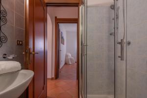 a bathroom with a shower and a sink and a toilet at Baia de Bahas Residence in Golfo Aranci