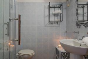 a bathroom with a toilet and a sink at Baia de Bahas Residence in Golfo Aranci