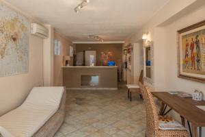 a living room with a bed and a dining table at Baia de Bahas Residence in Golfo Aranci