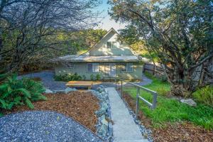 a house with a pathway leading to a yard at Dunrovin Vintage Beach Cottage - 1 Bed 1 Bath Vacation home in Port Orford in Port Orford