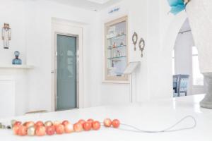 a white room with red balls on a counter at Stelia Mare Boutique Hotel in Naousa