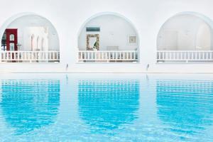 a pool of water in a house with three arches at Stelia Mare Boutique Hotel in Naousa