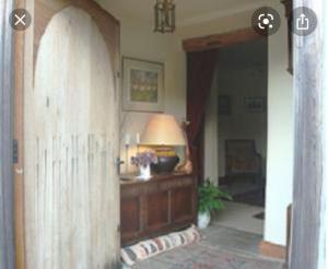 a hallway with a table and a lamp in a room at Loadbrook Cottages in Sheffield