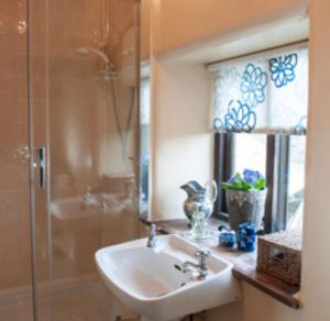 a bathroom with a sink and a shower at Loadbrook Cottages in Sheffield