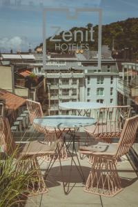 a table and chairs on the roof of a building at Zenit Convento San Martin in Donostia-San Sebastián