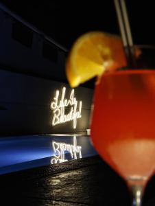 a drink with a lemon in front of a sign at Zenit Convento San Martin in Donostia-San Sebastián