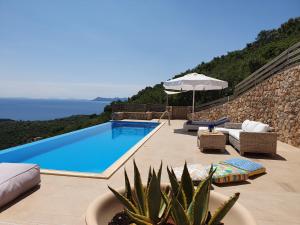 a villa with a swimming pool and a view of the ocean at Villa Albatross in Sivota