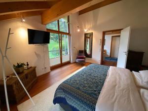 a bedroom with a bed and a flat screen tv at Kurzzeitdomizil in Oberstdorf in Oberstdorf