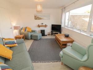 a living room with two couches and a tv at Seaside retreat in Porthmadog