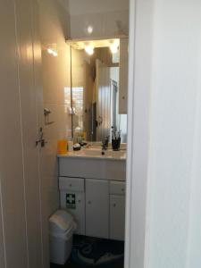 a bathroom with a sink and a toilet and a mirror at Casa Zona Velha - Caetano in Funchal