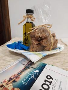 a plate of cookies and a bottle of oil on a table at Meltemaki in Mouzákion